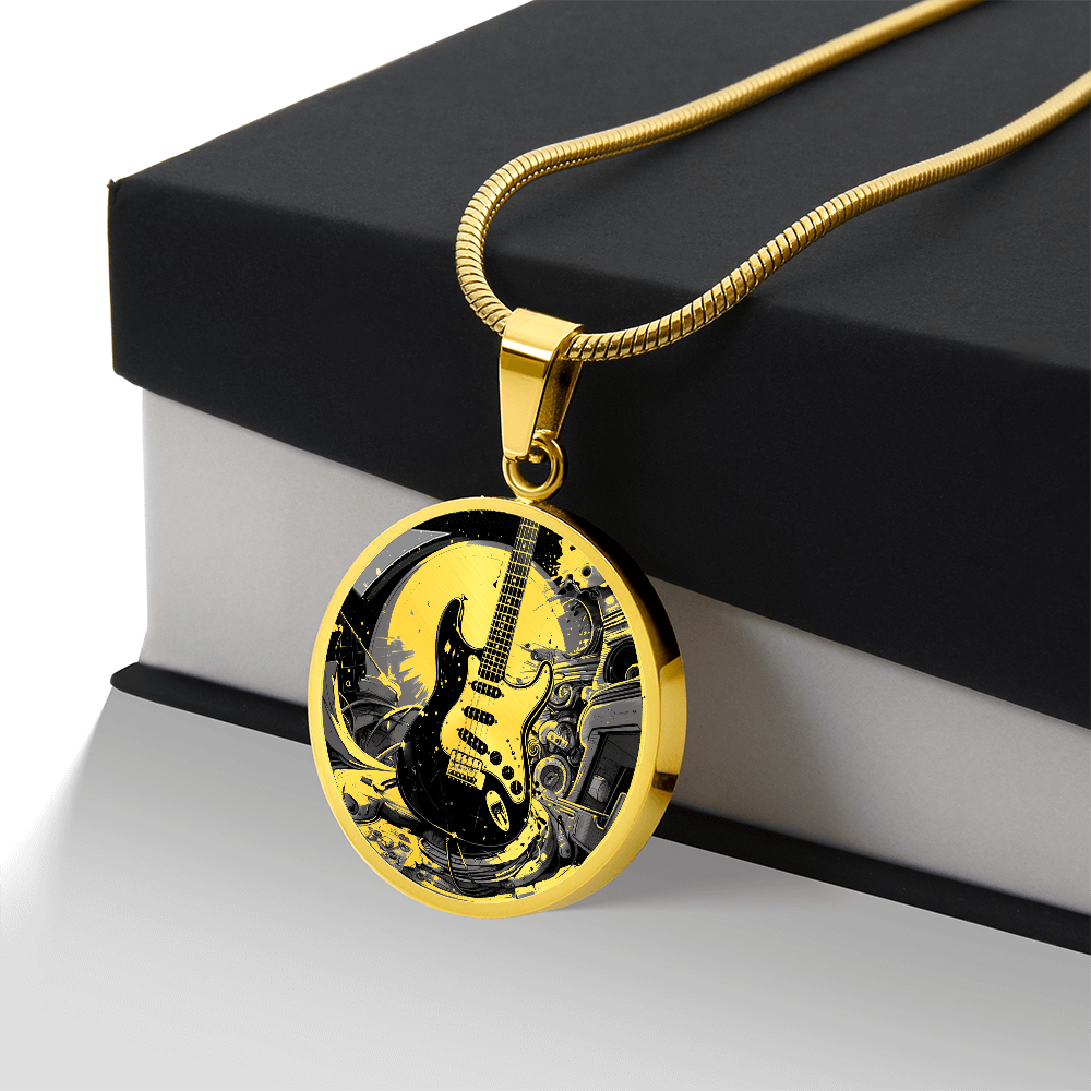 Electric guitar necklace featuring a black Strat-style guitar with cream pickguard against intricate black and gold artwork on a round pendant.