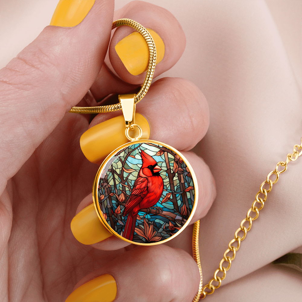 Stained glass-inspired cardinal necklace featuring a vivid red Northern Cardinal surrounded by colorful mosaic-style foliage on a round pendant.