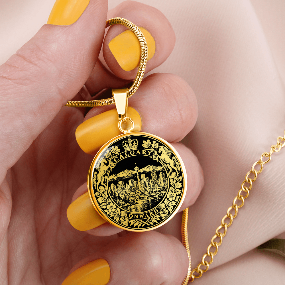 Gold finish Calgary skyline pendant featuring Calgary Tower, mountain landscape, heraldic horses and ornate circular border