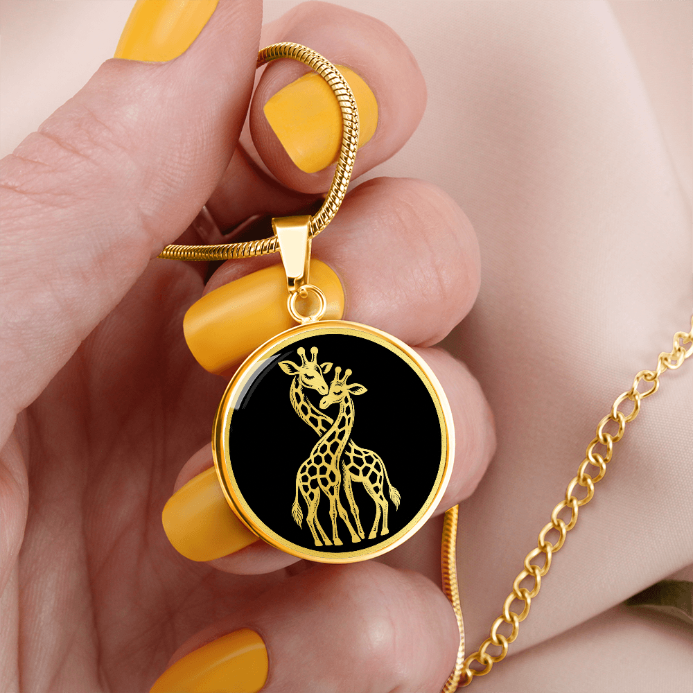 Gold finish two giraffes necklace featuring gold-toned artwork of intertwined giraffes against a black round pendant.