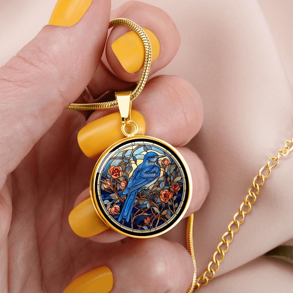Gold Blue Jay necklace featuring colorful cloisonné-inspired bird artwork on a round pendant, a thoughtful gift for bird lovers.