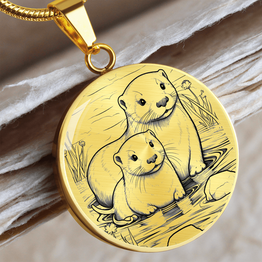 Gold Sea Otter Couple Necklace featuring two otters together in a delicate black-and-white shoreline illustration on a silver-colored pendant.
