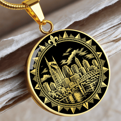 Gold finish Nashville skyline pendant featuring Music City buildings, river reflections and ornate circular emblem