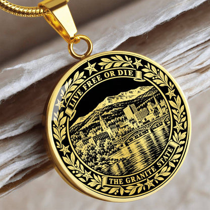 Gold finish New Hampshire pendant featuring mountain landscape, lakeside buildings, Live Free or Die and Granite State inscriptions