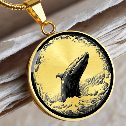 Breaching whale necklace with detailed black-and-white illustration of a whale rising from ocean waves on a silver-colored round pendant.