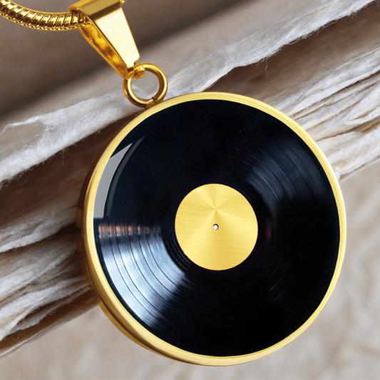 Vinyl record necklace featuring realistic black LP artwork with circular grooves and silver center label on a round pendant.