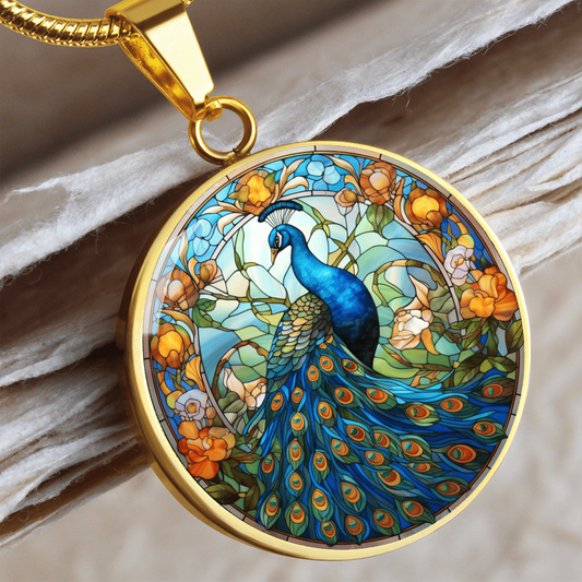 Gold finish peacock necklace displaying vivid blue peacock artwork and decorative flowering branches.