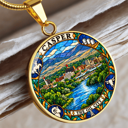 Gold finish Casper Wyoming stained glass pendant showing mountain scenery, winding river, city buildings and ornate wildlife border