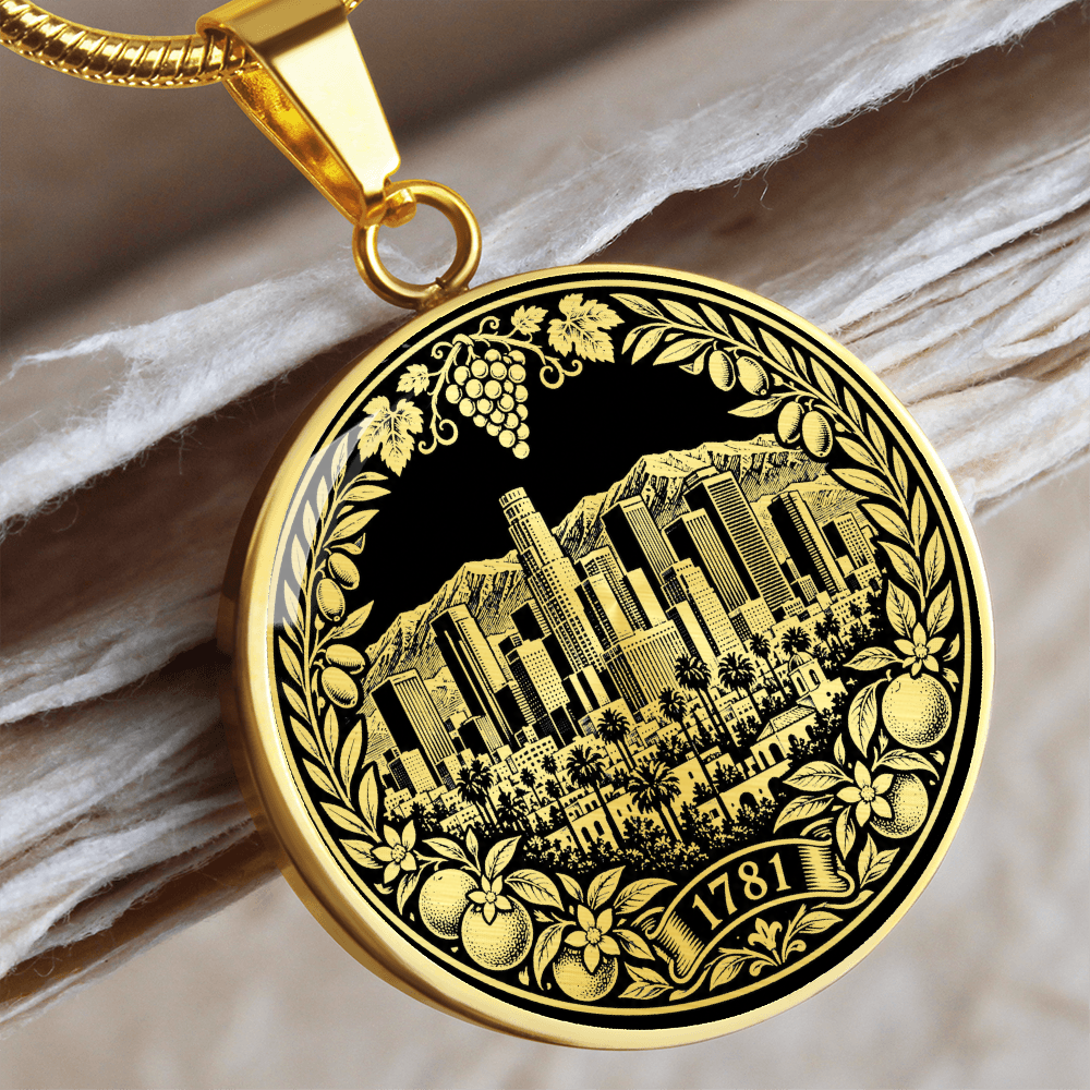 Gold Los Angeles skyline necklace featuring downtown skyscrapers, palm trees, mountains, citrus fruit and 1781 botanical emblem