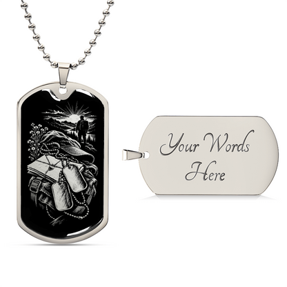 Close-up of silver deployment necklace showing tied envelopes with heart, two hanging military-style tags and flowers beside a backpack.