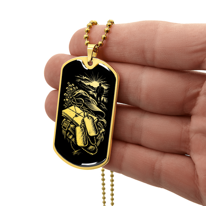 18K gold finish long distance military dog tag necklace with gold-toned illustration of backpack, letters and sunrise on black.