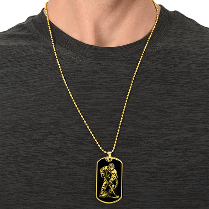 Gold finish hockey dog tag necklace with bold black-and-white hockey artwork