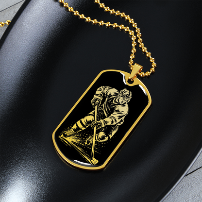 Gold finish hockey dog tag necklace with bold black-and-white hockey artwork