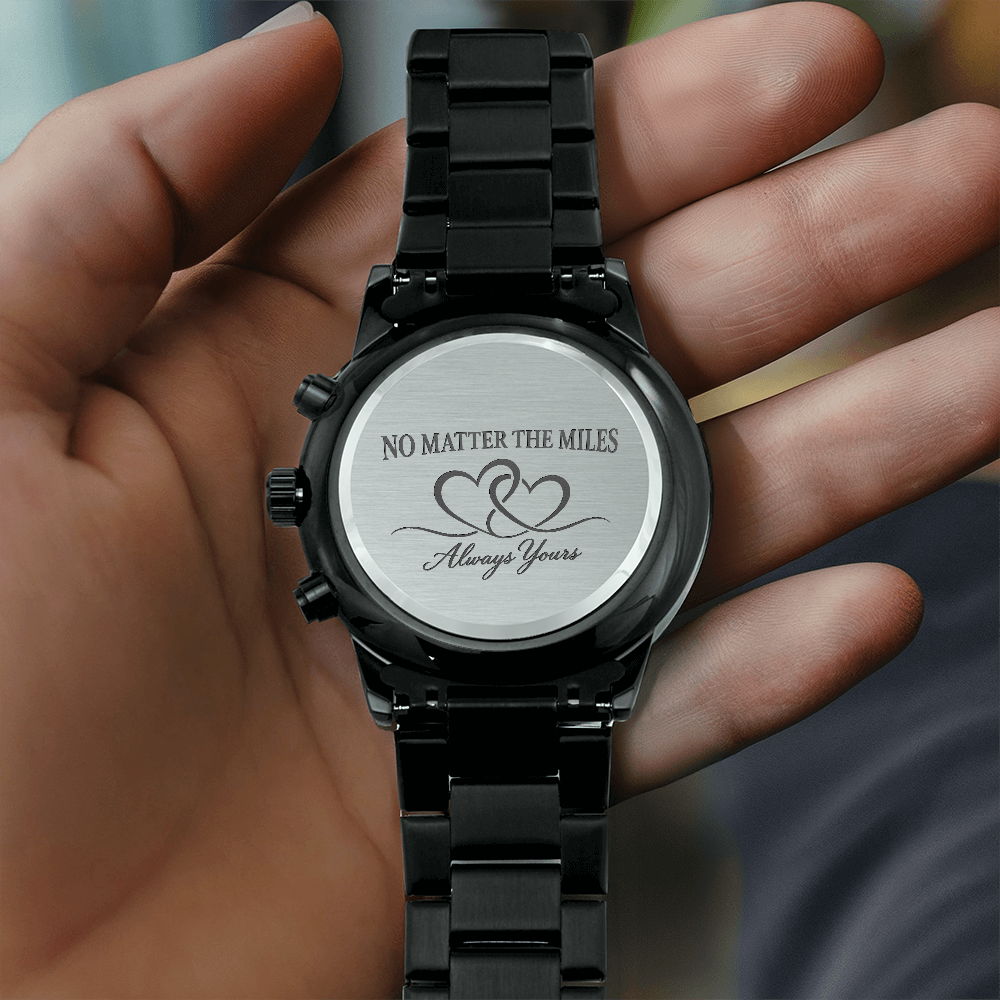 Black long distance relationship watch for men showing front chronograph-style dial and engraved back reading No Matter the Miles Always Yours.