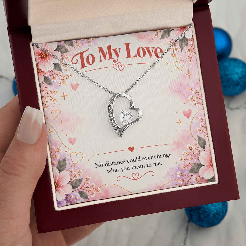 Silver-toned Forever Love heart necklace displayed in black gift box with floral To My Love card and romantic distance message.