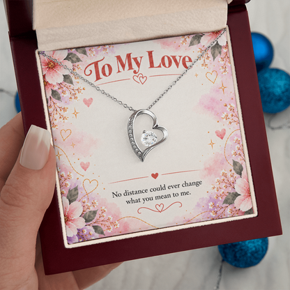 Silver-toned Forever Love heart necklace displayed in black gift box with floral To My Love card and romantic distance message.