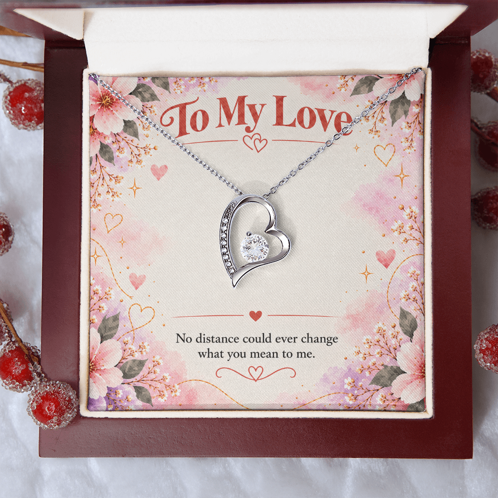 Silver-toned Forever Love heart necklace displayed in black gift box with floral To My Love card and romantic distance message.