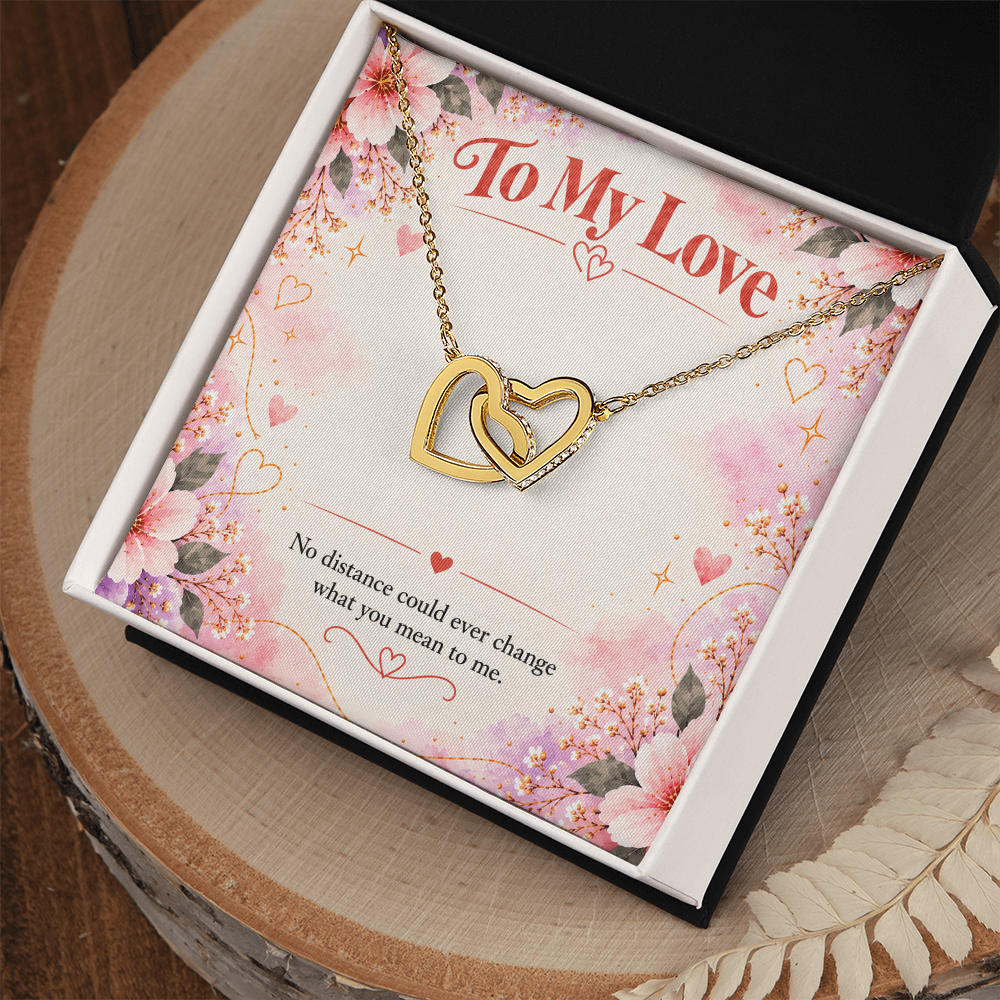 Interlocking hearts necklace presented in a jewelry gift box, with two linked heart pendants and matching chain.