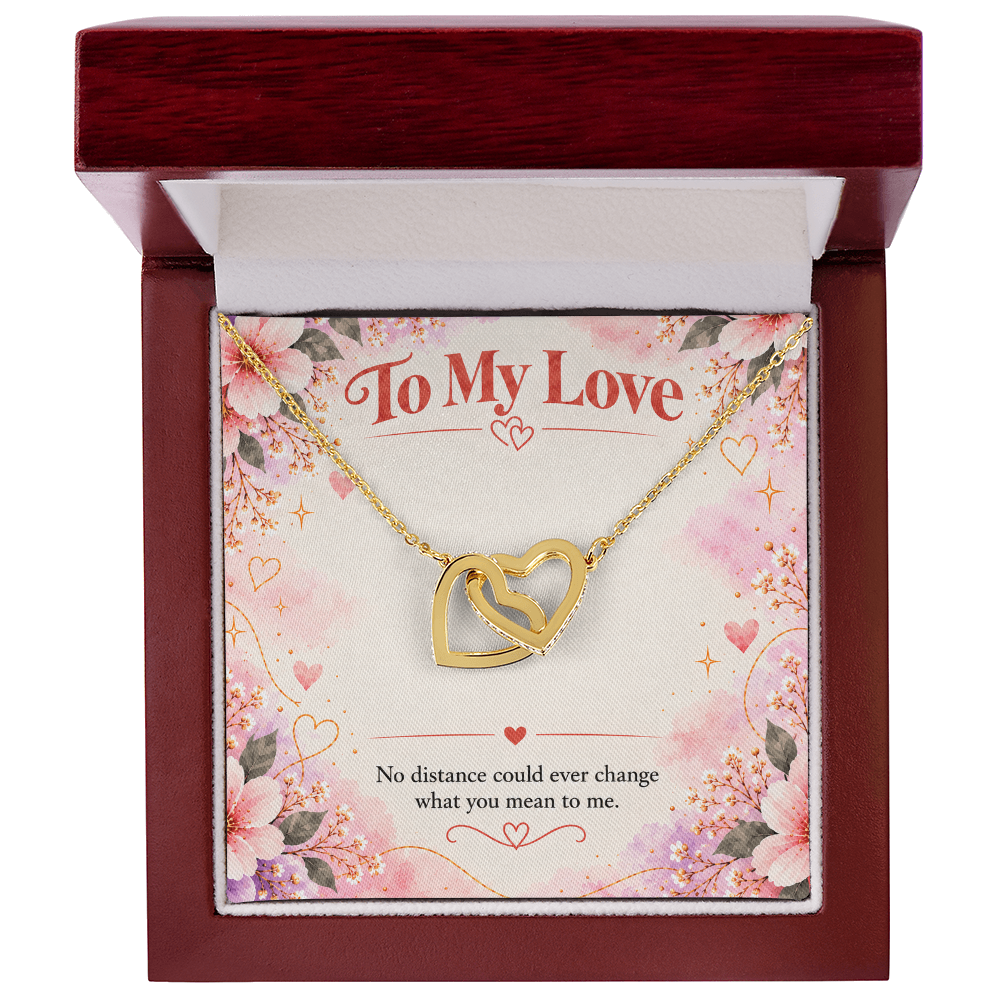 Interlocking hearts necklace presented in a jewelry gift box, with two linked heart pendants and matching chain.