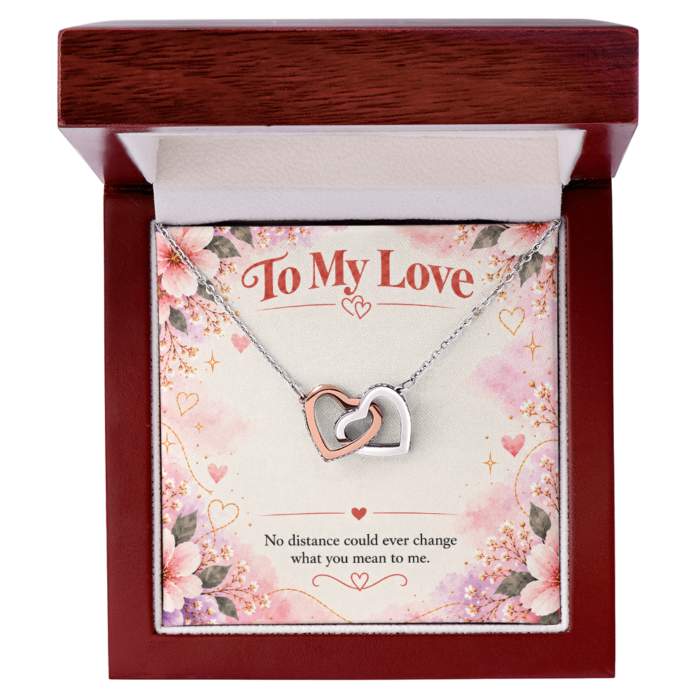 Interlocking hearts necklace presented in a jewelry gift box, with two linked heart pendants and matching chain.