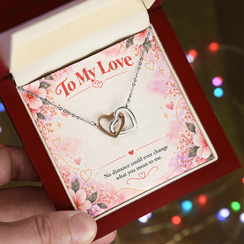 Interlocking hearts necklace presented in a jewelry gift box, with two linked heart pendants and matching chain.