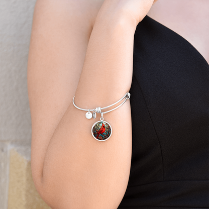 Red cardinal bracelet worn on wrist with circular bird charm