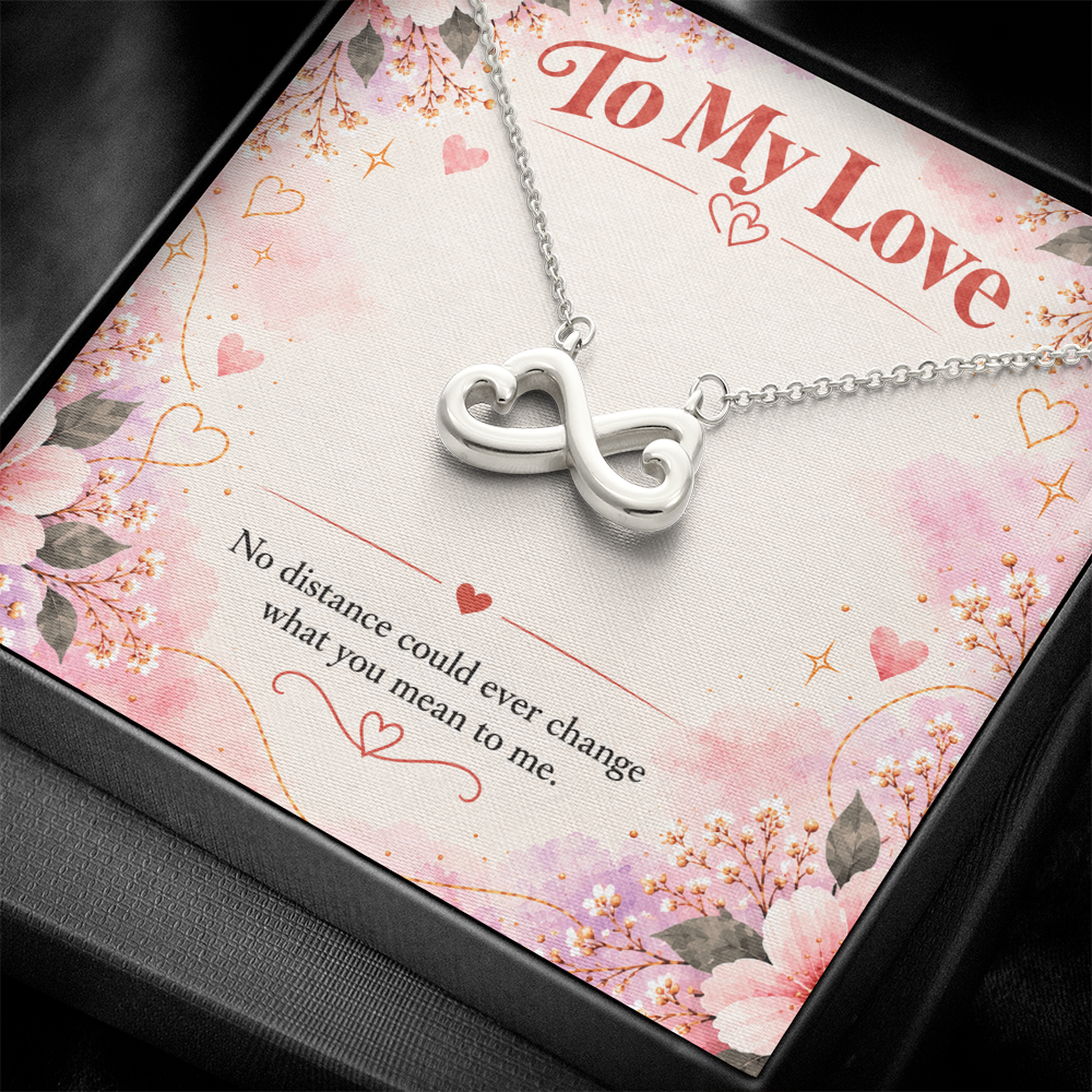 14K white gold finish infinity hearts necklace on pink floral card reading No distance could ever change what you mean to me.