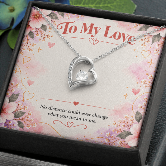 Forever Love heart necklace with sparkling cubic zirconia displayed on pink floral To My Love long-distance relationship message card.