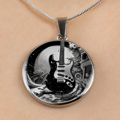 A round pendant necklace featuring a black and white graphic illustration of a classic electric guitar, displayed on a model's skin with a silver chain.